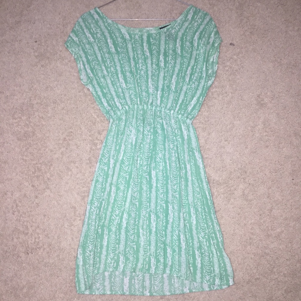 Turquoise dress with white details/patterns